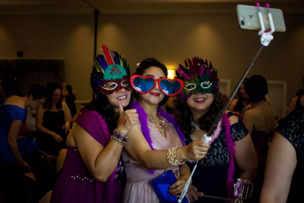 Cherry Morency (left to right), Rae Asari and Carol Andersan take a selfie wearing photo booth props at Concord Mom Prom at the Grappone Center in Concord on Friday, May 12, 2017. (ELIZABETH FRANTZ / Monitor staff) Elizabeth Frantz