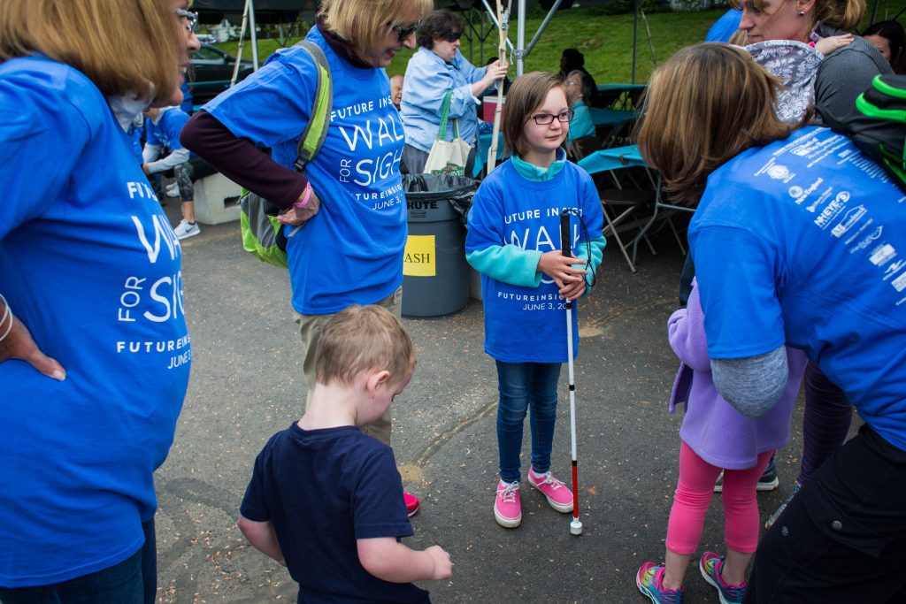 Seven-year-old Delaney Kelly (center) stands among family and friends before the start of Saturday's Walk for Sight outside the Future in Sight office in Concord on June 3, 2017. (ELIZABETH FRANTZ / Monitor staff) Elizabeth Frantz
