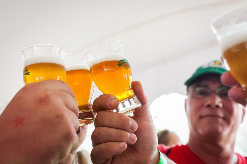 A group makes a toast before drinking a sample of craft beer at the New Hampshire Brewers Festival at Kiwanis Riverfront Park in Concord on Saturday, July 22, 2017. (ELIZABETH FRANTZ / Monitor staff) ELIZABETH FRANTZ