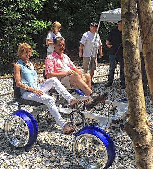 Carolyn Leblanc (right) and husband Gary Leblanc sit astride one of Scenic Railriders' railbikes on Friday. Scenic RailRiders opened up tours along former railroad track in Concord this weekend. City of Concord