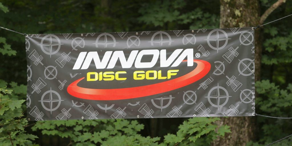 A banner hangs near the entrance at Top O’ The Hill Disc Golf Course in Cantebury. Innova is one of the top manufacturers of disc golf discs.