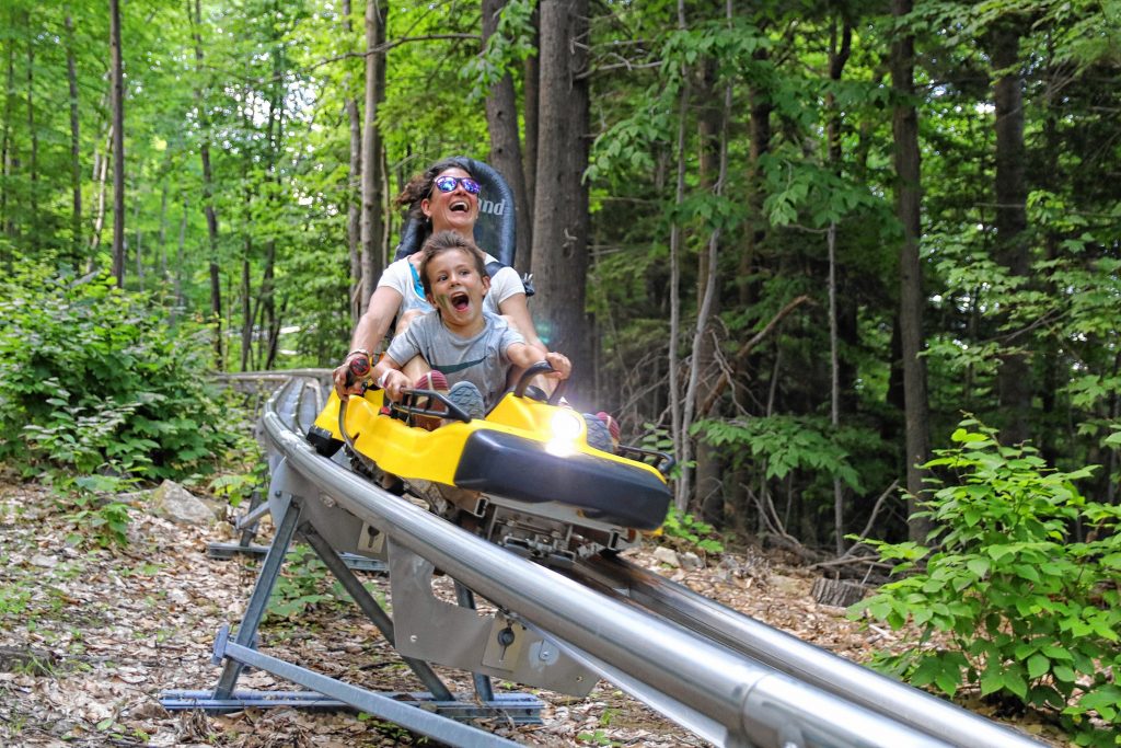 One of the more exciting attractions at Gunstock is the mountain coaster, which lets you control your own speed (to some extent) as you cruise your way down the mountain. Gunstock marketing manager Rachel Templar and her son Oliver seem to be having a blast trying it out. Courtesy of Rachel Templar / Gunstock Mountain Resort