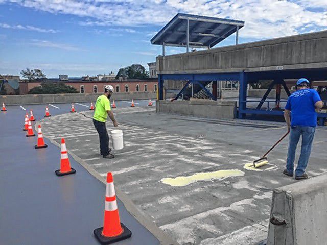 Workers install waterproofing membrane at the School Street parking garage. Courtesy of City of Concord