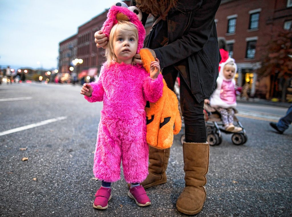 Allison Parkington, 2, gets her headress adjusted by her mom at the Halloween Howl on Main Street in Concord on Friday evening, October 25, 2019. GEOFF FORESTER