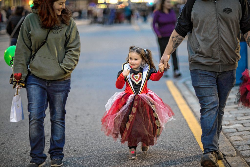 Elena Walker, 3, walks with her parents at the Halloween Howl in downtown Concord on Friday evening, October 25, 2019. GEOFF FORESTER