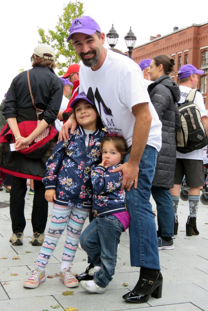 Brandon Roberts and his daughters Regan (standing) and Aubrey) post at the Walk a Mile in Her Shoes 2018 event on Wednesday, October 3 2018. Caitlin Andrews