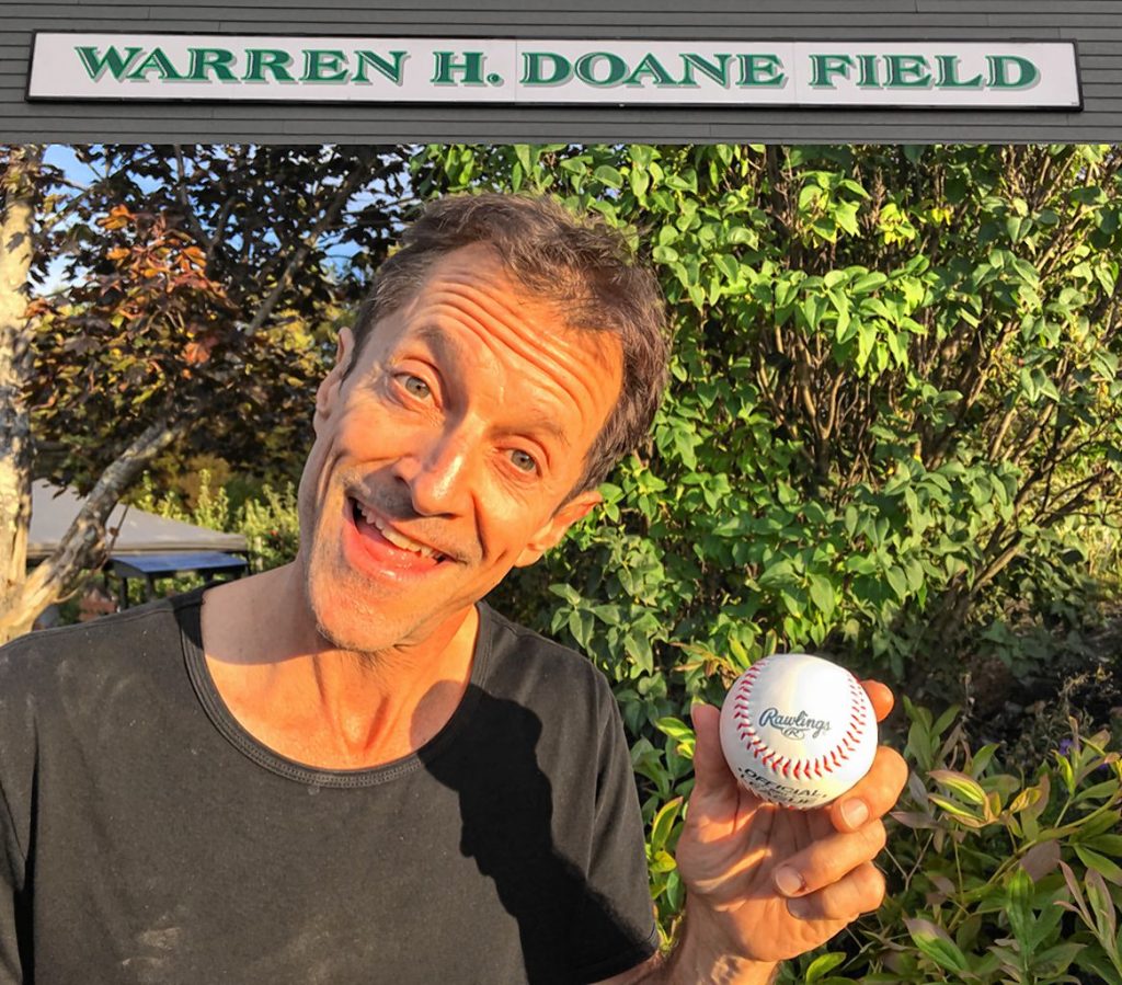 Mike Morris holds a baseball at Warren Doane Field. When he played high school baseball for Doane, the coach taught him how to narrow his focus, and it's translated into a career in yoga. Courtesy of Mike Morris
