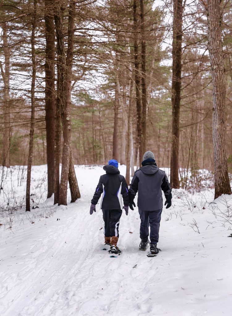Nick Aiello, right, and Savannah Wunderlich snowshoe through the trails at Wendell State Forest on Saturday afternoon in Wendell.  Staff Photo/Dan Little