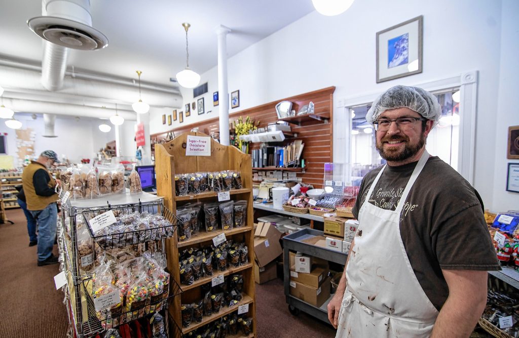Production manager Caleb Ruopp of the Granite State Candy store on Warren Street on Thursday, December 12, 2019. GEOFF FORESTER