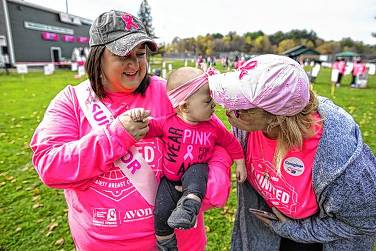 Lucy Freese gets a kiss from Grandma Dana Allison as aunt Jessica Allison holds her niece at Memorial field on Sunday, October 20, 2019. GEOFF  