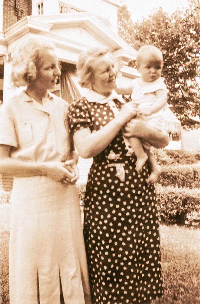 Mimi, as an infant, with her mother and grandmother, who she was told adopted her, but were actually her biological family.