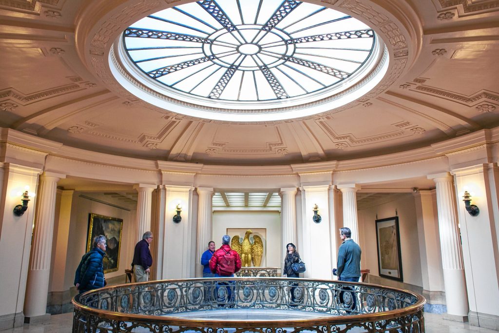 A tour group gathers on the second floor in front of the oculus, the circular opening defined by the skylight, at the New Hampshire Historical Society on Park Street in Concord on Friday, Feb. 17, 2017. (ELIZABETH FRANTZ / Monitor staff) ELIZABETH FRANTZ