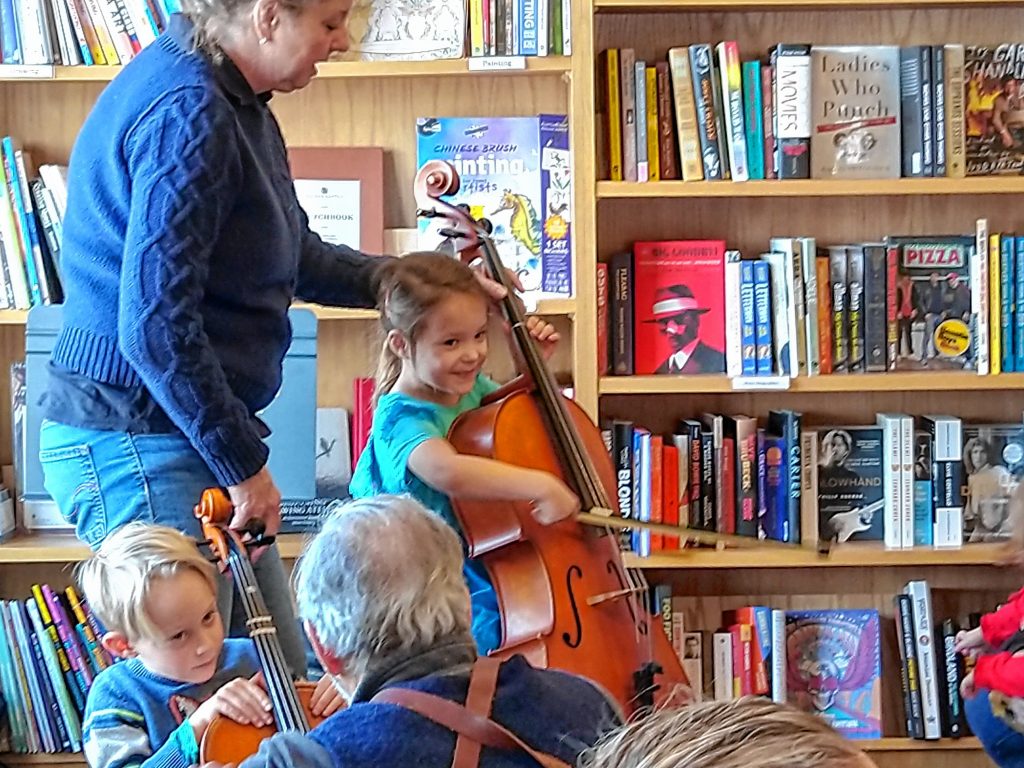 Noelle “Ellie” Speck learns about the violin family of instruments from Melissa Perley.   