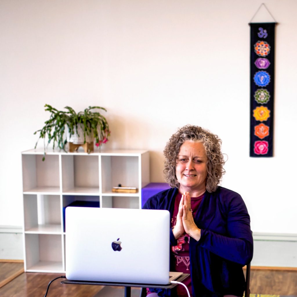 Instructor Candy Jackson leads an online yoga class at Sharing Yoga from the studio on North Main Street in Concord on Tuesday.