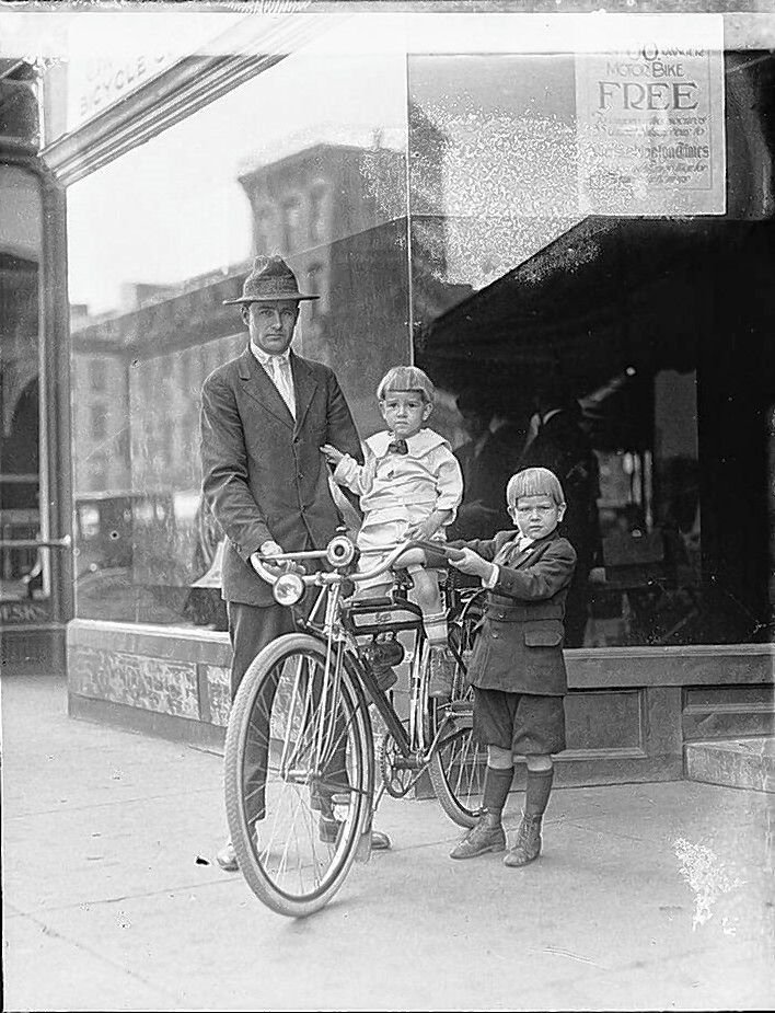 A family poses with their bicycle in 1917.  