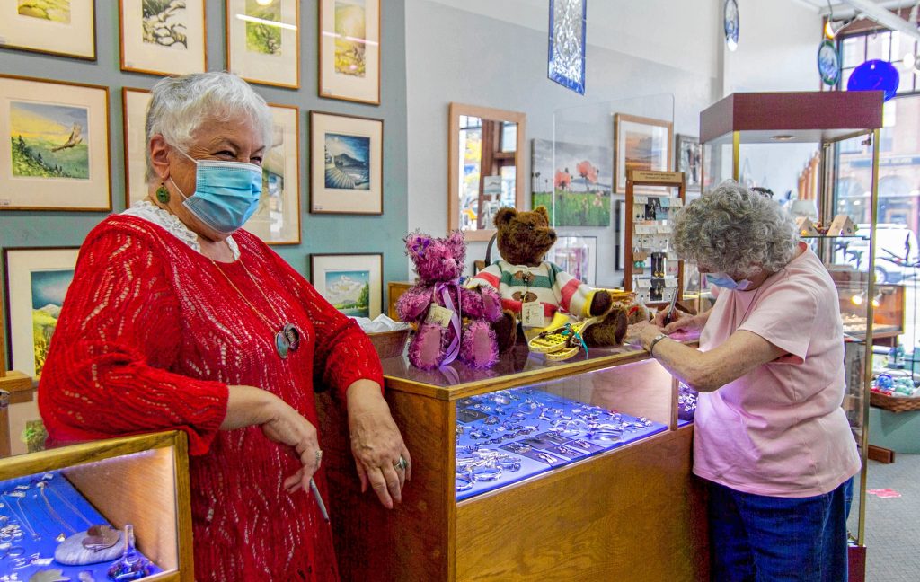 Employee Penny Verville (left) and crafter Diana Lynd (right) at the counter of  League of NH Craftsman located in Downtown Concord on Main Street October 1st, 2020. ALLIE ST PETER