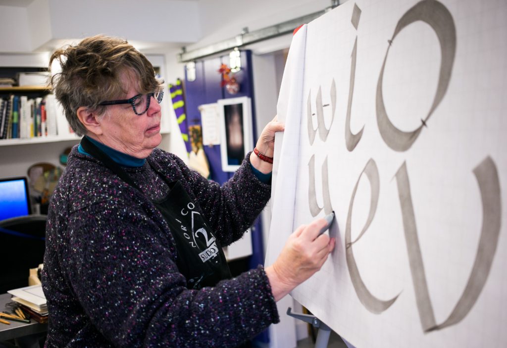 Adele Sanborn shows how to make a 'W' during her introductory calligraphy class at the Twiggs Gallery in Boscaswen last weekend. Sanborn says the 'W' is the most difficult letter to produce. 