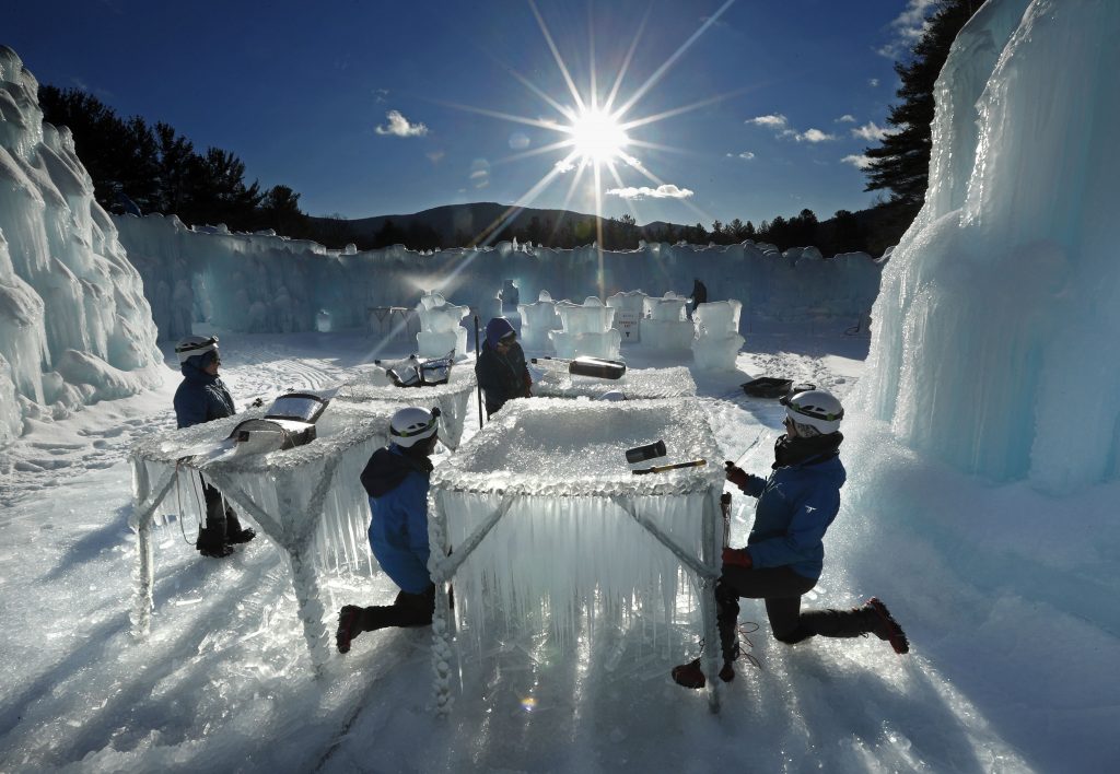 In this Monday, Jan. 28, 2019 photo, icicles are harvested for use in growing the walls at Ice Castles in North Woodstock, N.H. The winter wonderland is one of six in North America. (AP Photo/Robert F. Bukaty)  Robert F. Bukaty