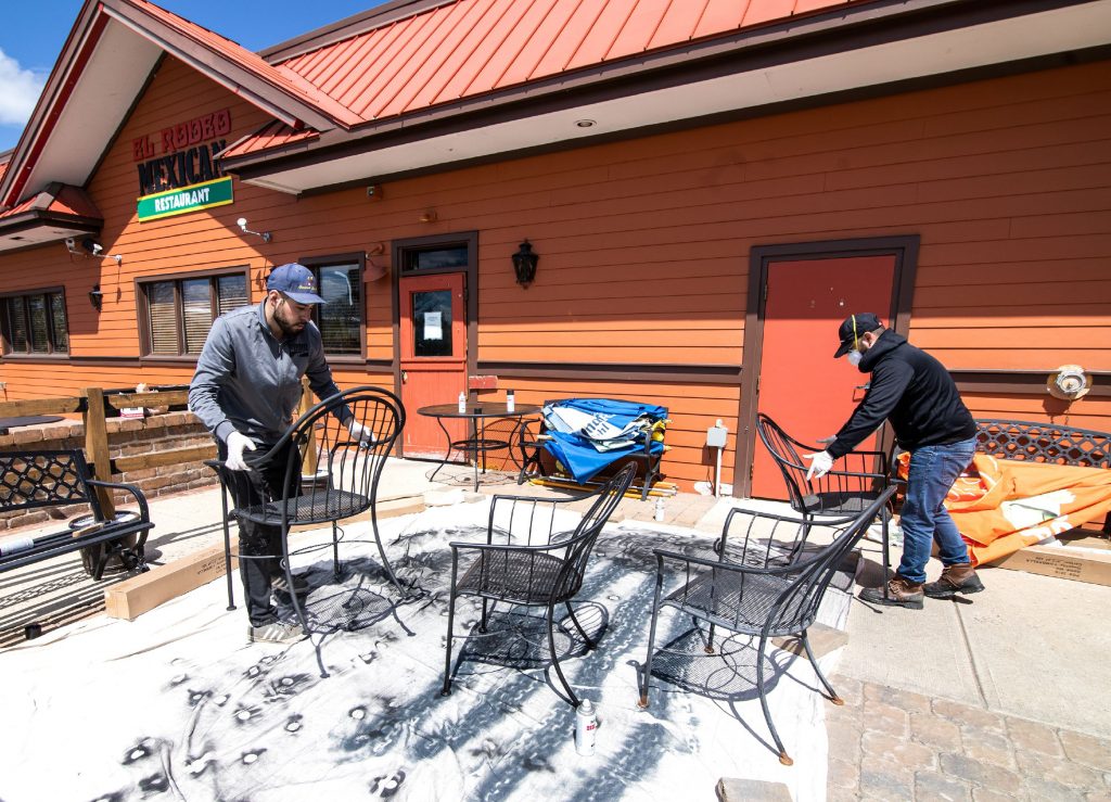 Charlie Lopez (left) and Jose Ramirez spray paint chairs in one of the two new patio areas on Tuesday, May 11, 2020 that El Rodeo Mexican Restaurant will be offering on May 18th as outdoor seating will be available.  