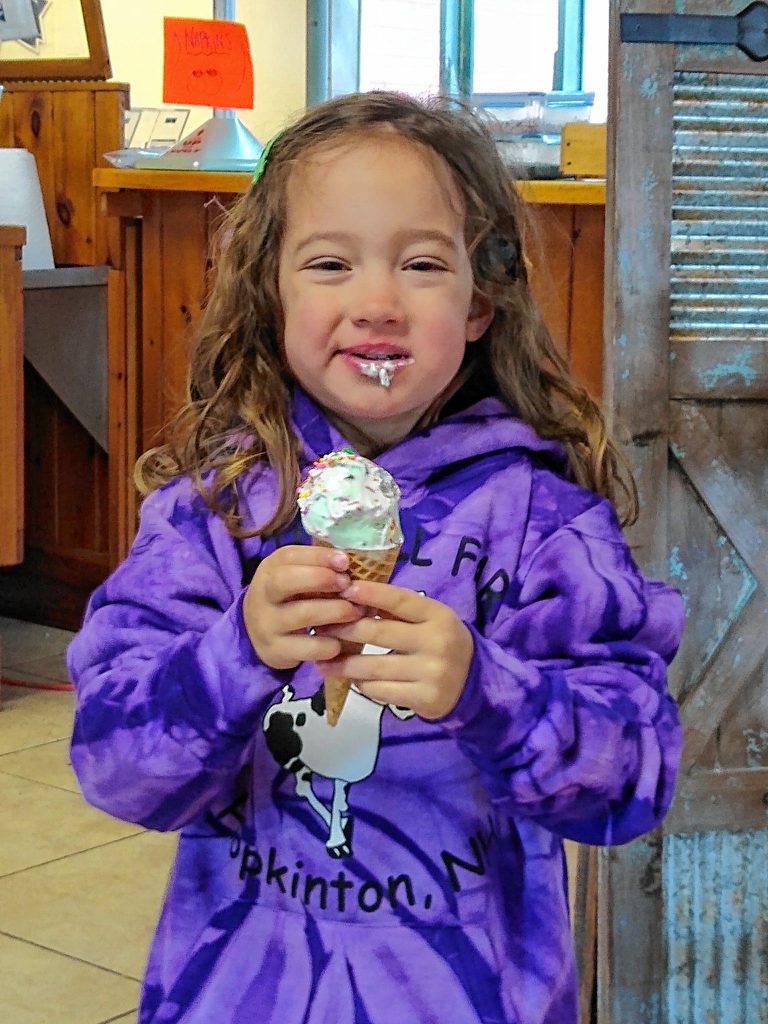 A satisfied customer enjoys her ice cream at Beech Hill Farm.  