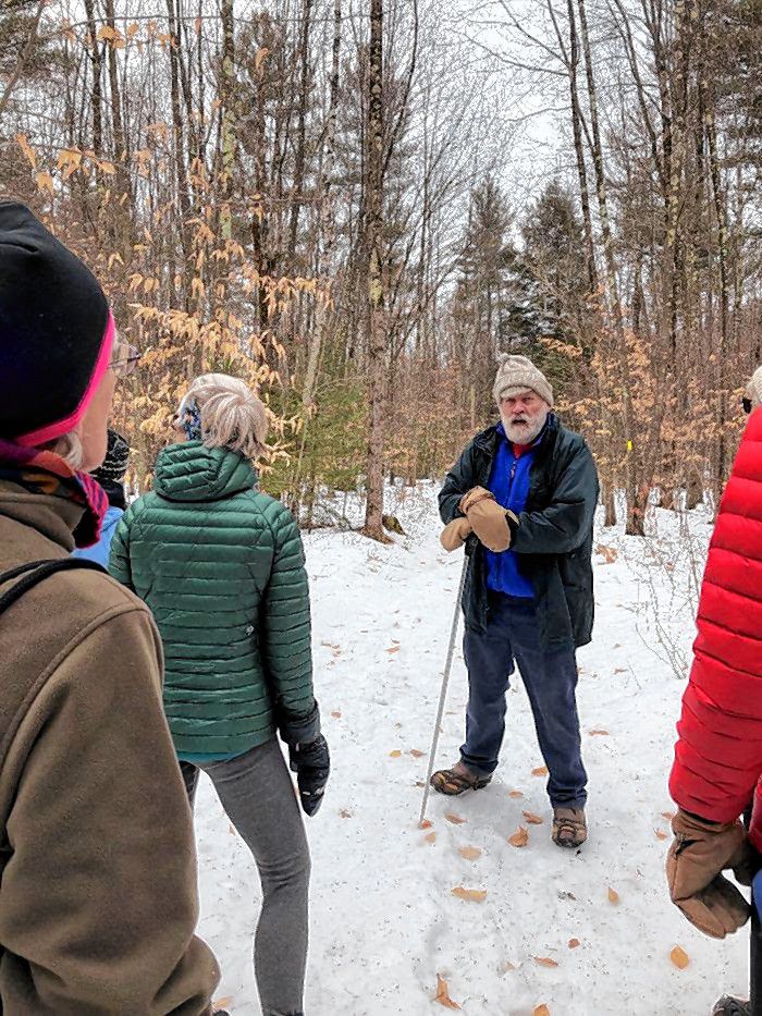 A group learns about sustainable forestry practices from the city’s consultant forester, Ron Klemarczyk.
