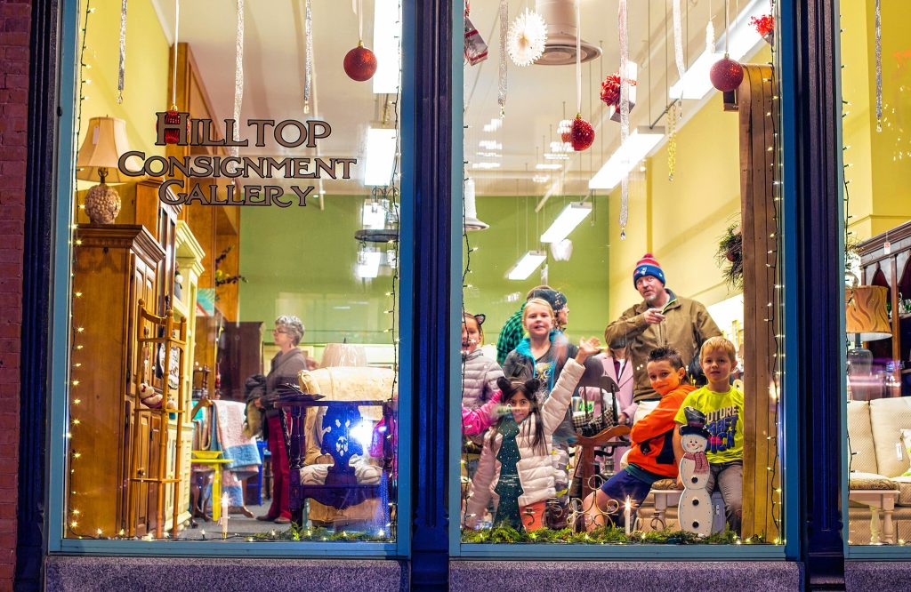 The Osmer and Soucie families and their friends check out the Hilltop Consignment Gallery on Main Street during Midnight Merriment in 2018. 