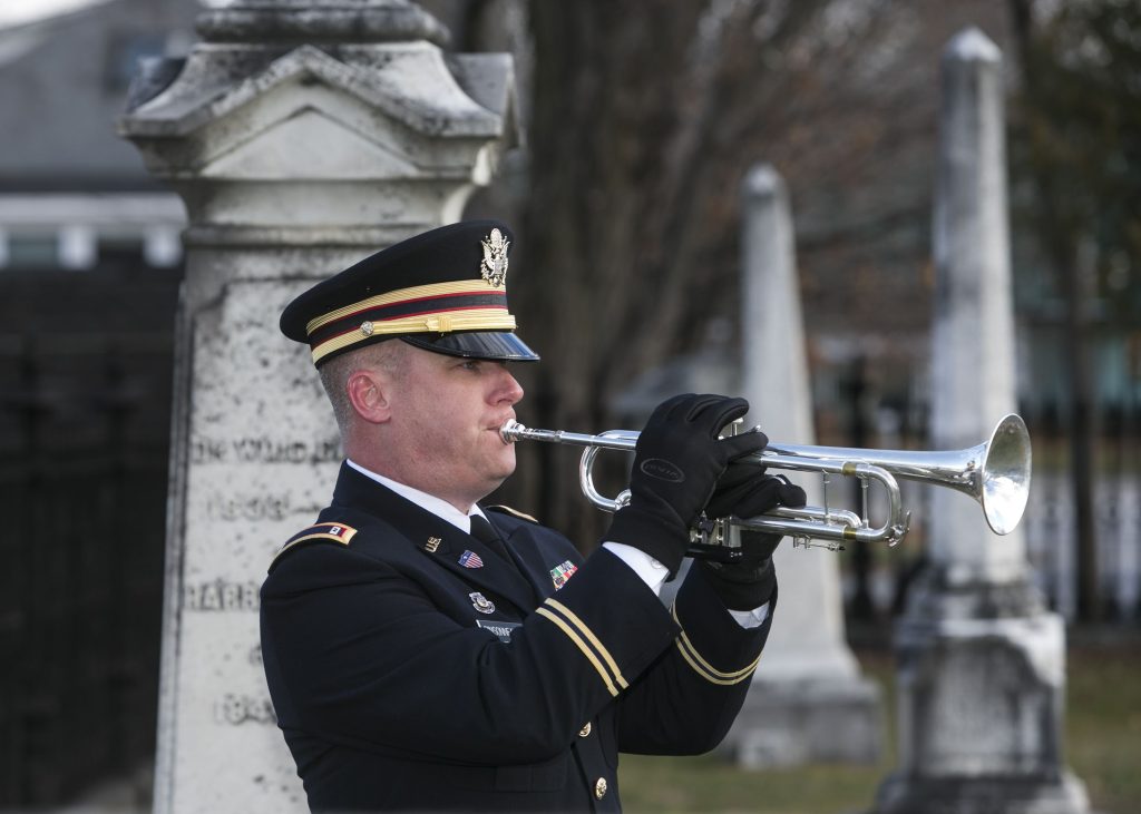 CW2 Sean Pinssoneault of the 39th Army Band plays taps at the ceremony marking the birth of President Franklin Pierce in 1804 at Old North cemetery in Concord on Tuesday. Will Parson