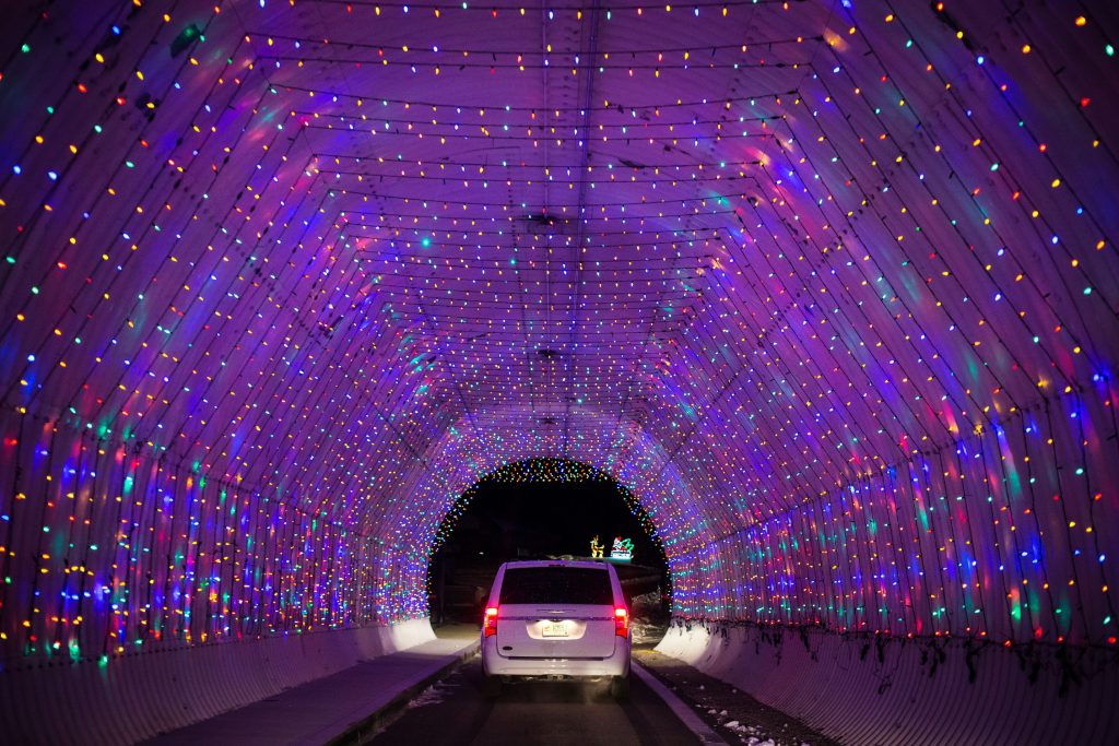 A car passes through an illuminated infield tunnel as it drives along the two-mile Christmas lights display called Gift of Lights at the New Hampshire Motor Speedway in Loudon on Friday, Dec. 16, 2016. (ELIZABETH FRANTZ / Monitor staff) ELIZABETH FRANTZ