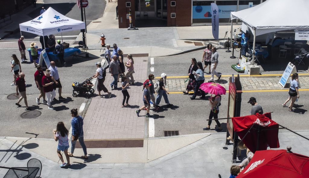 People walk up and down North Main Street in Concord on the first day of Market Days on Thursday, June 22, 2023.  GEOFF FORESTER