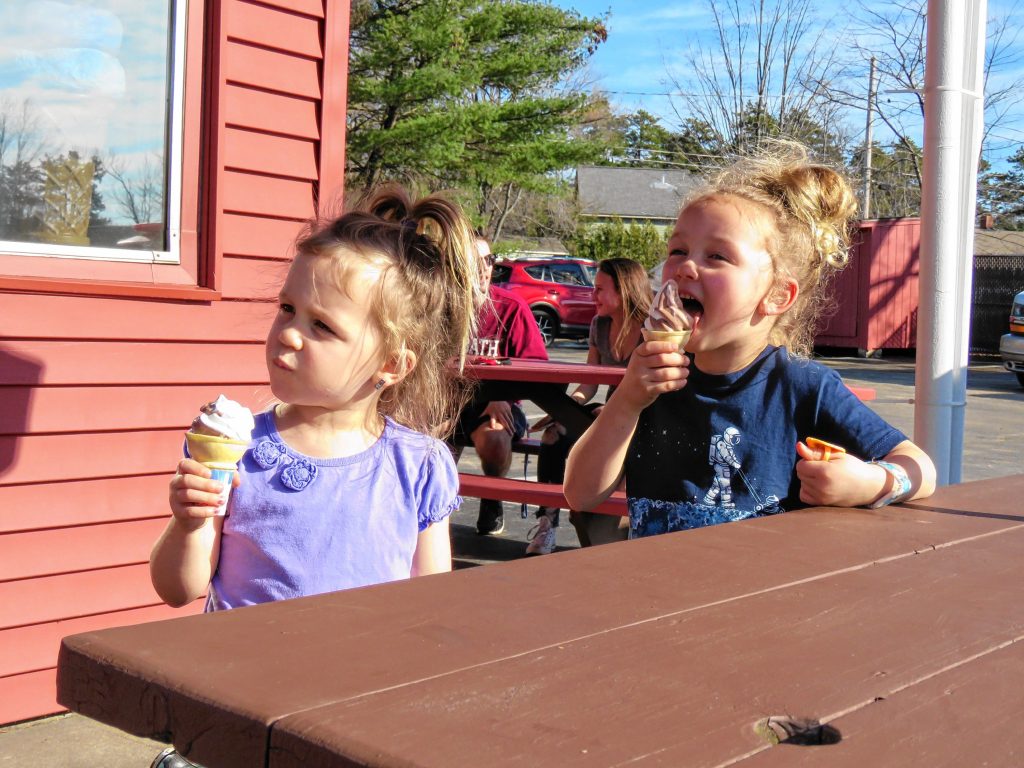 Adeline (left, 3) and Ella (5) Lundquist of Hopkinton eat a chocolate-vanilla twist ice cream cone at Arnie's Place on Wednesday, Feb. 21, 2018. Caitlin Andrews