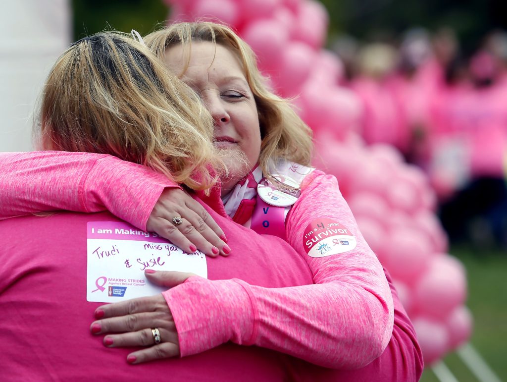 Nurse Patty Labrie of Manchester hugs another survivor before the 2016 Making Strides against Breast Cancer Walk at Memorial field Sunday. Labrie says the Concord American Cancer Society event is like family for her. 