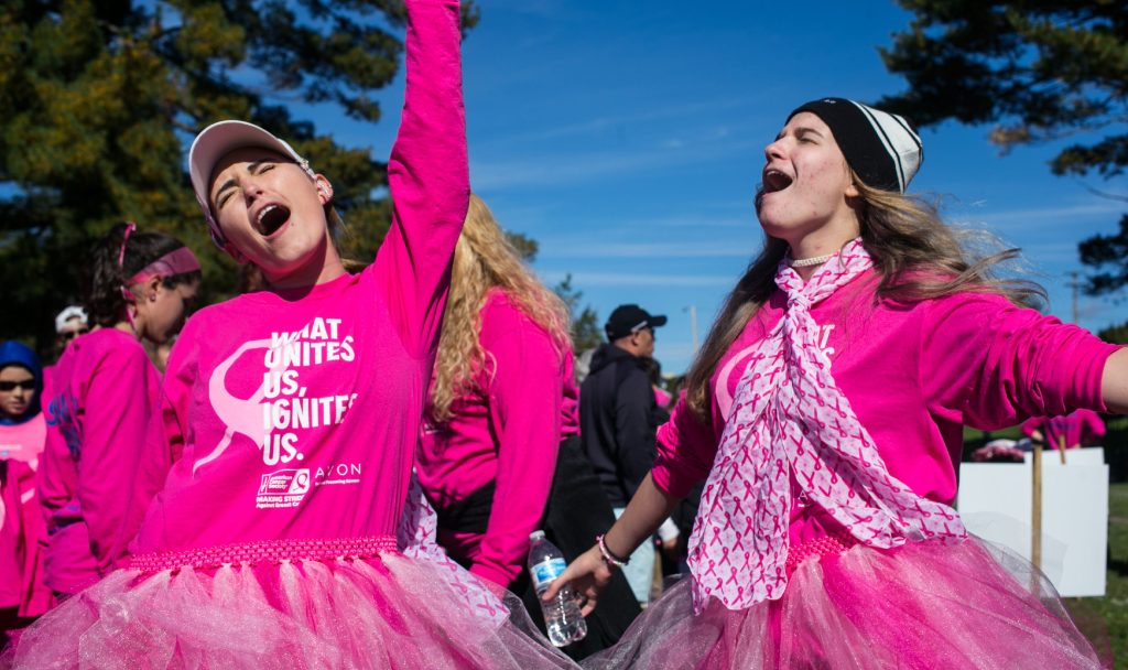 Cousins Andera (left) and Emily Little belt out 'Don't Stop Believing' at the 26th annual Making Strides Breast Cancer Walk at Memorial Field on Sunday October 14, 2018. The cousins were there in support of their grandmother who has been a cancer survivor for 43 years. 