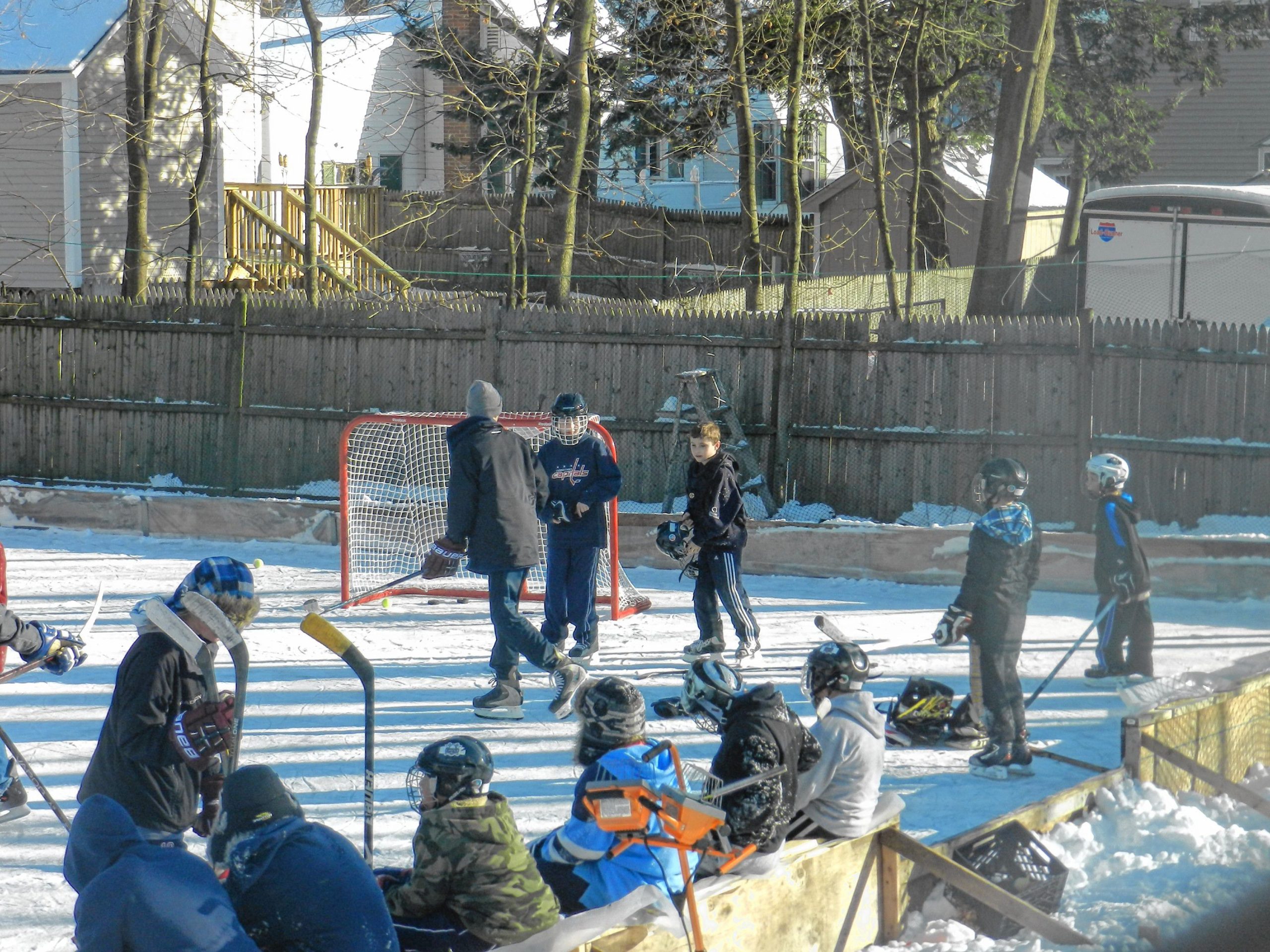 Kids play on the outdoor hockey rink at the Philbrick house. Oct. 23