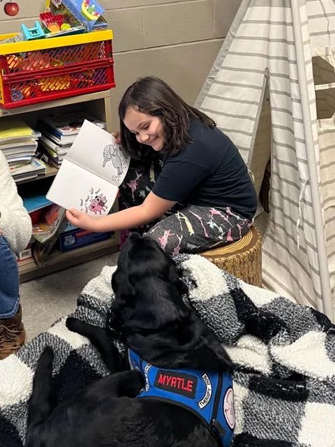 Kearsarge Elementary School student Laurel Osteen reads to Myrtle.